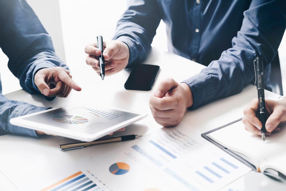 Asian business adviser meeting to analyze and discuss the situation on the financial repor