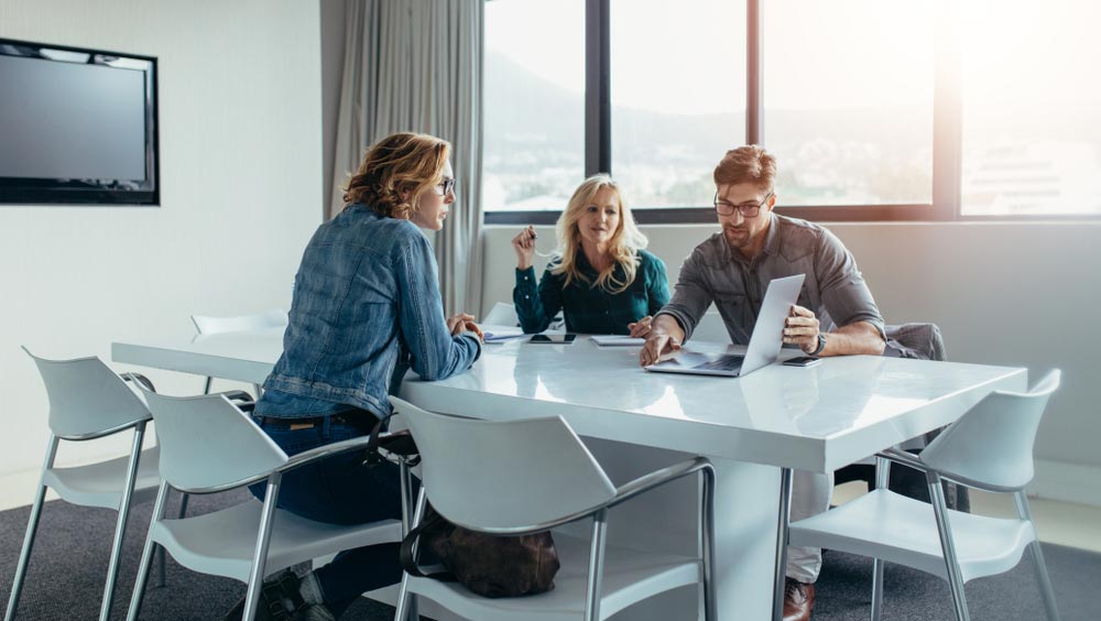 Businessman giving presentation to colleagues at meeting