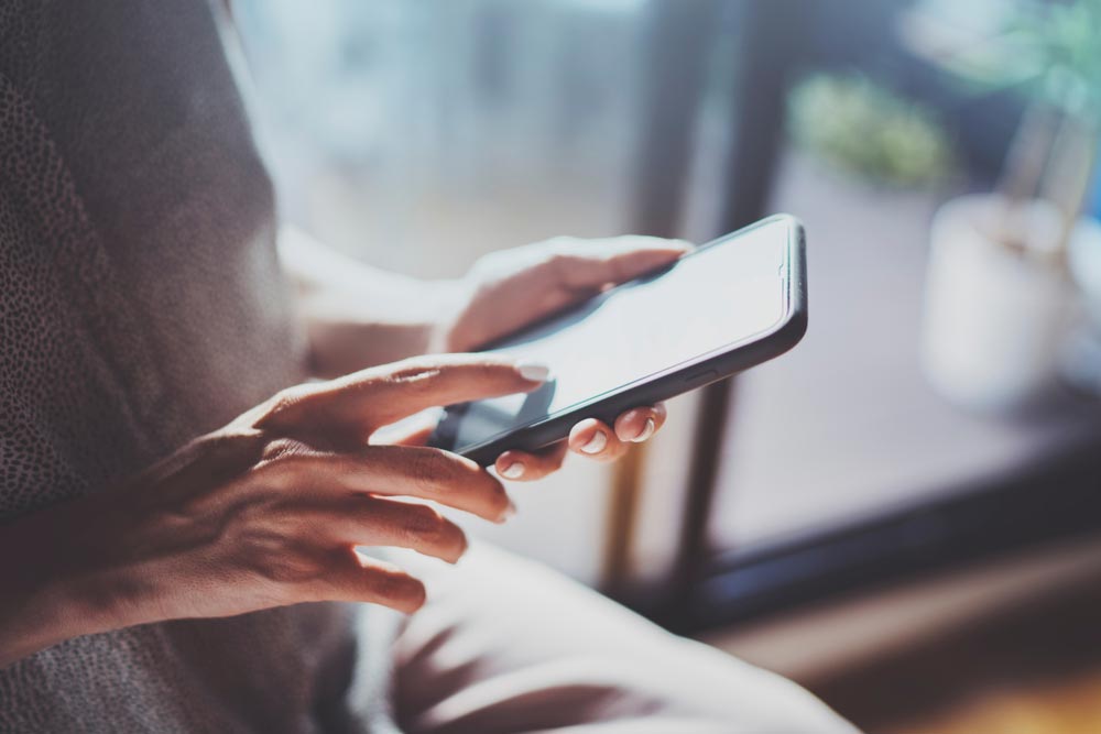 Female hands using mobile phone